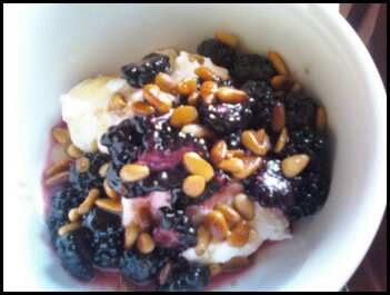 Greek yogurt with blackberries, toasted pine nuts and honey.